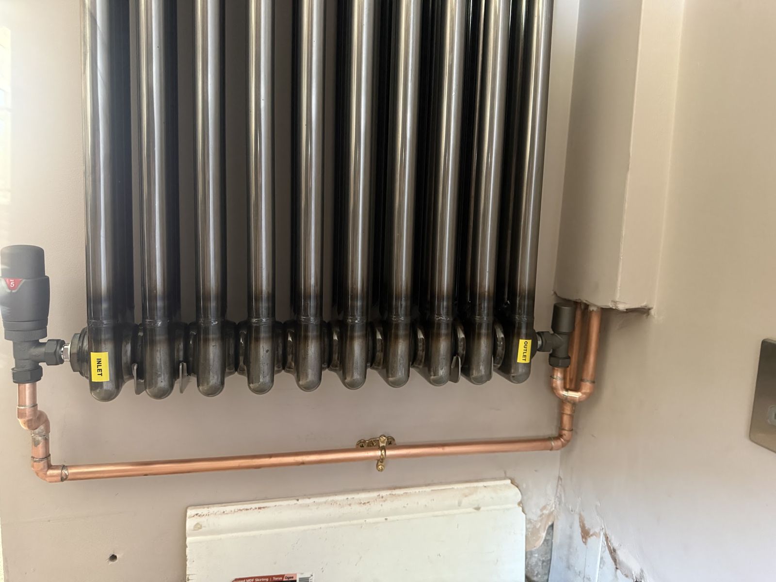 Anthracite column radiator with a thermostatic valve and new copper pipework